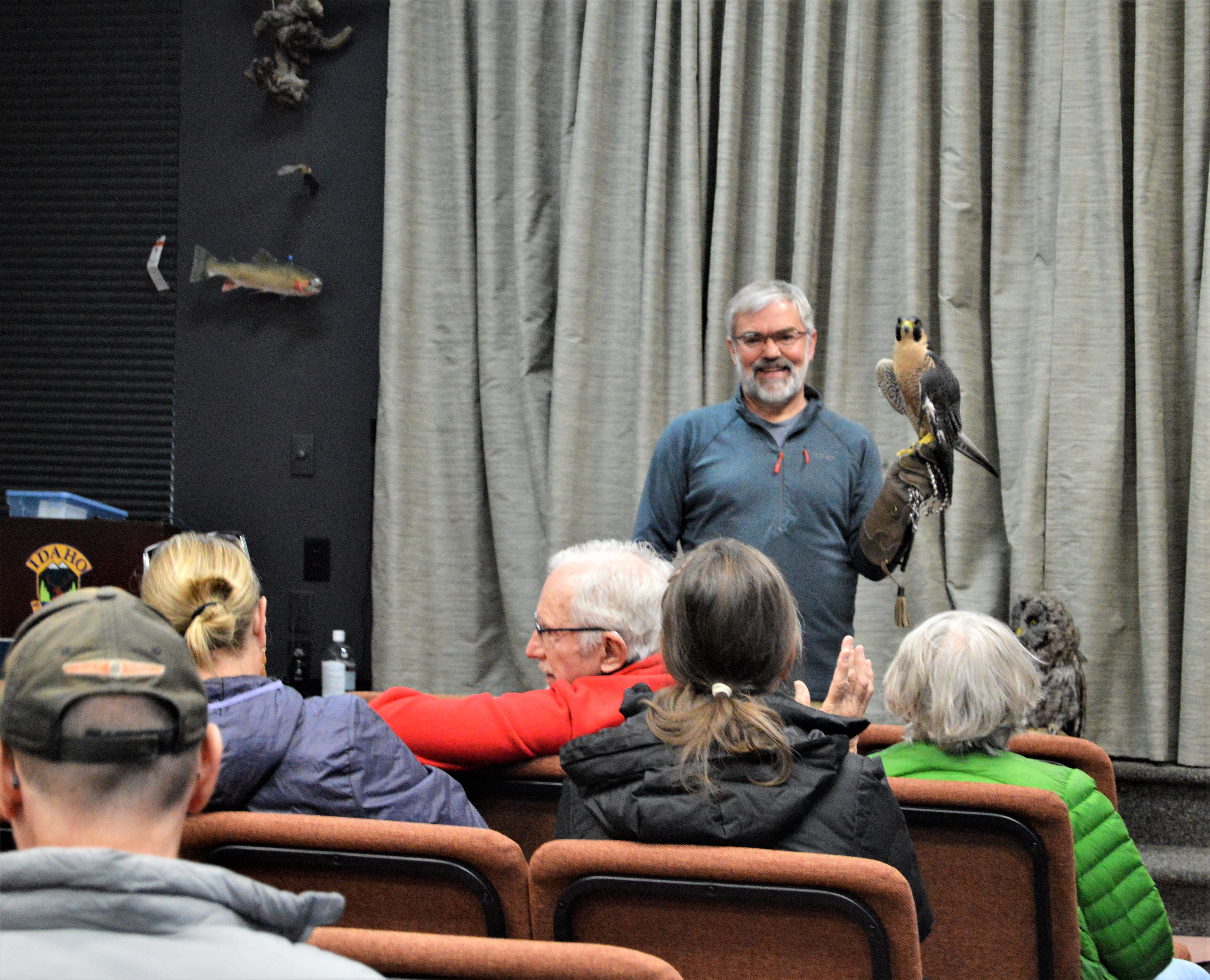man holding a peregrine falcon at MK Nature center bird seed sale