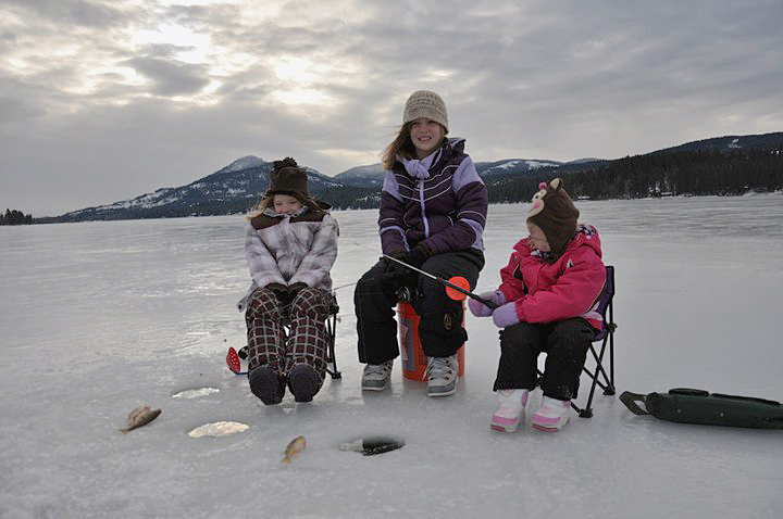 Three sisters dressed for ice fishing on Cocolalla Lake