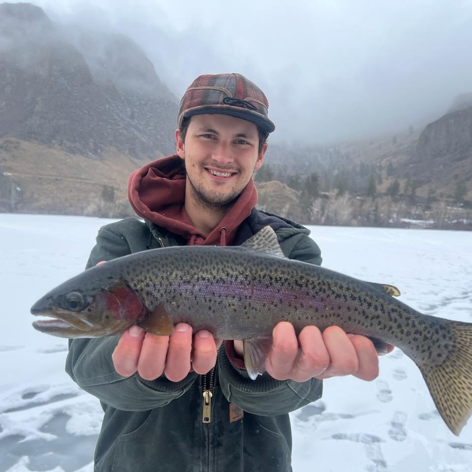 IDFG fishery technician holding an 18.25 inch Rainbow Trout caught through the ice at Williams Lake in January, 2024.