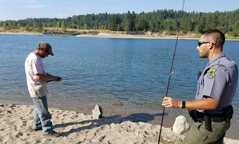 Conservation Officer checks an anglers license
