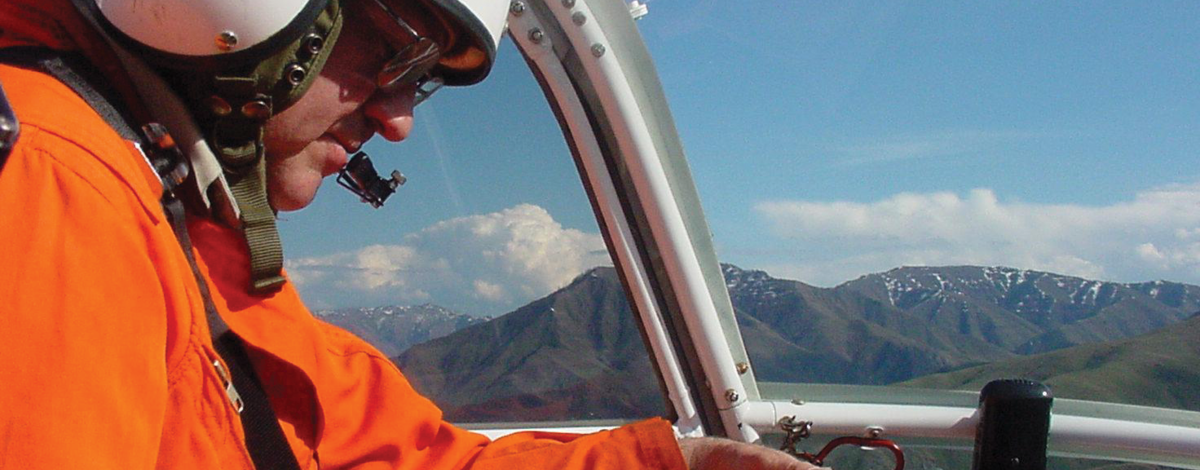 researcher in a helicopter taking notes March 2001