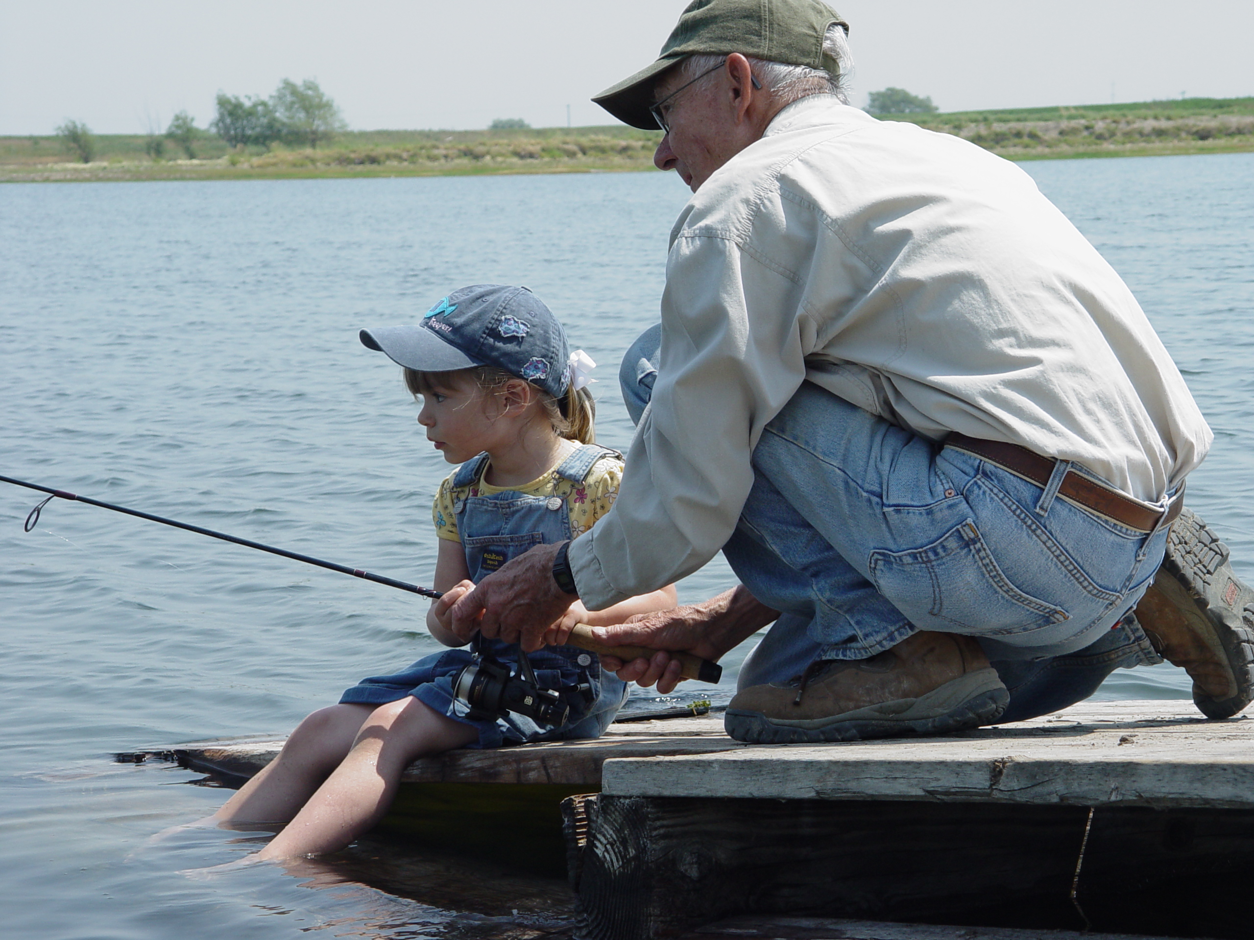 Little girl fishing with Grandpa