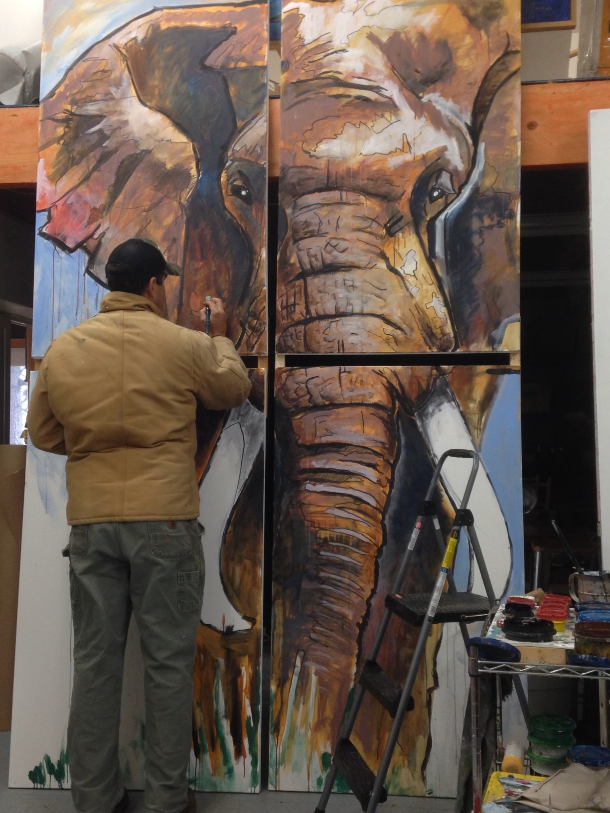 Ed Anderson painting a mural of an elephant