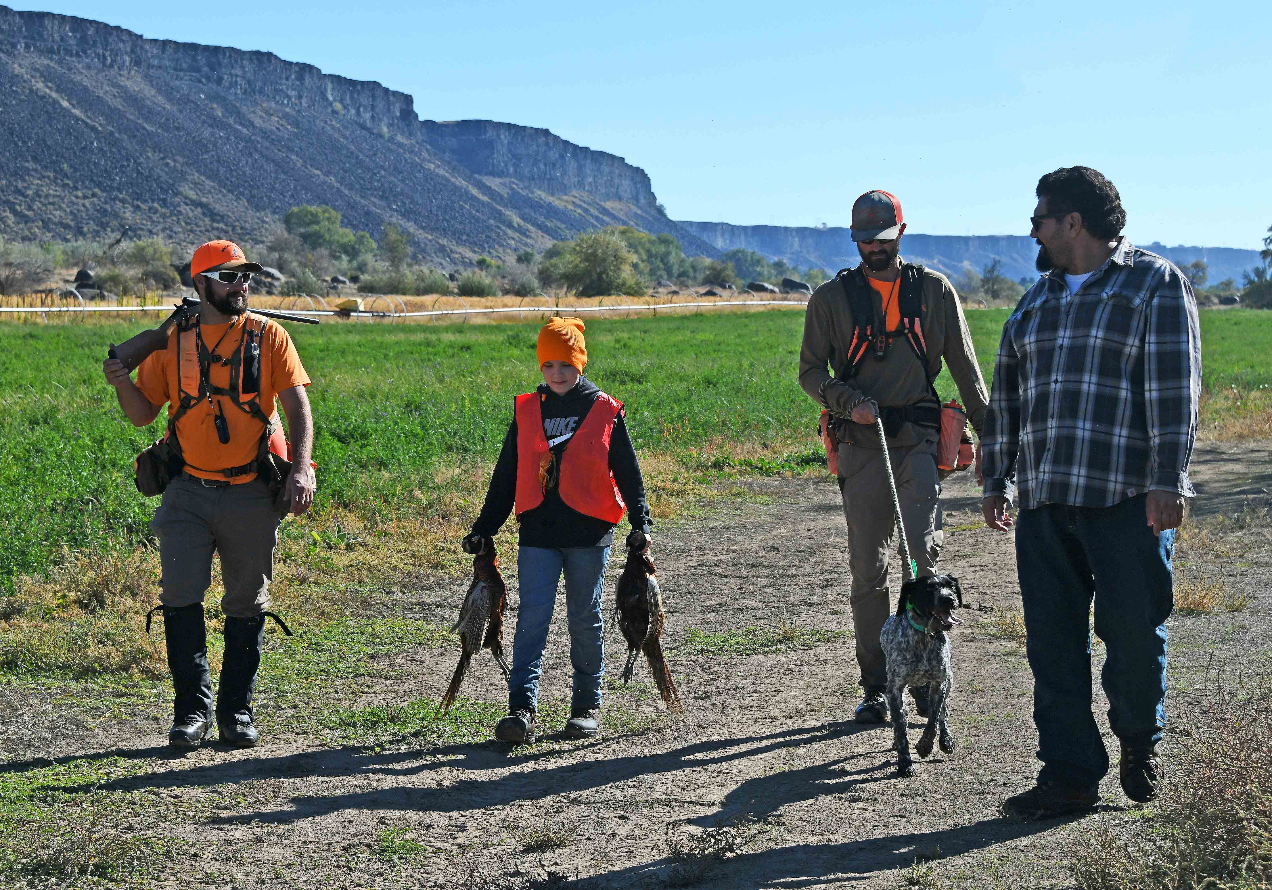 A successful youth hunter with dog club and hunter education mentors.
