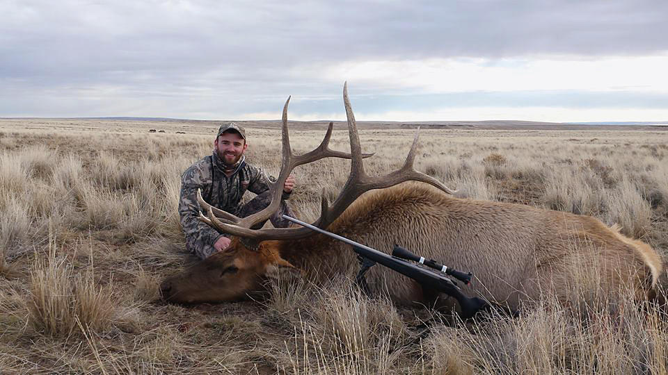 Clint Irving with his bull elk and rifle 2014 Superhunt success February 2015