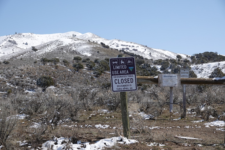 Landscape photo of the Stinking Springs area including a closure sign