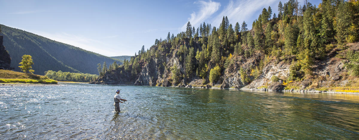 wide shot of an angler fly fishing on the Kootenai River during a Fish and Game fish survey September 2015