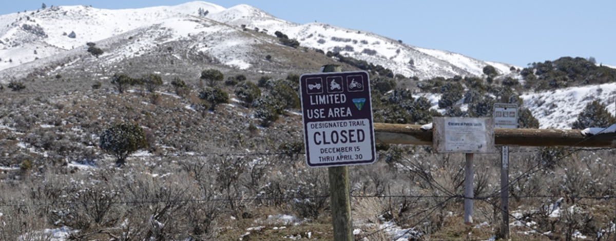 Landscape photo of the Stinking Springs area including a closure sign